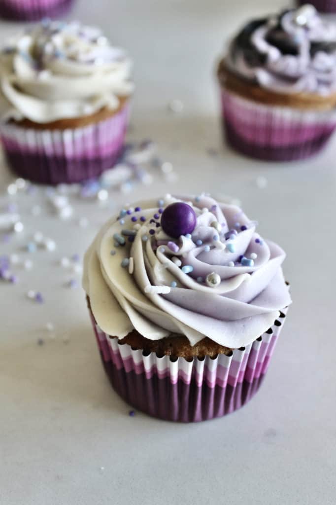 Swirled cupcake, purple and white with colorful sprinkles