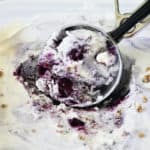 Scoop of swirled blueberry ice cream with crumble