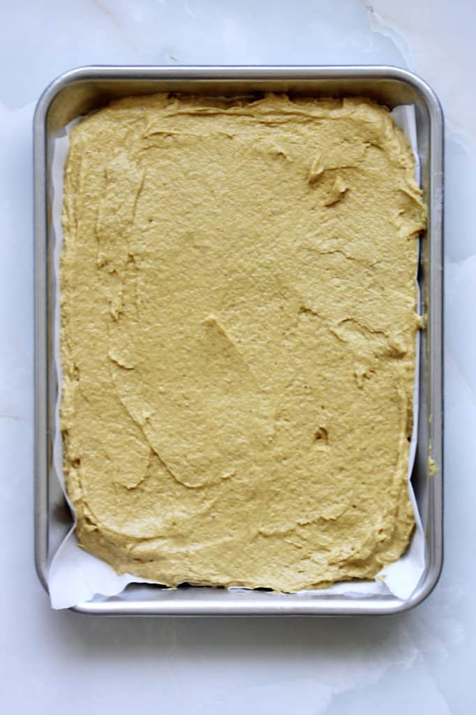 Batter for pumpkin cake spread in quarter sheet pan