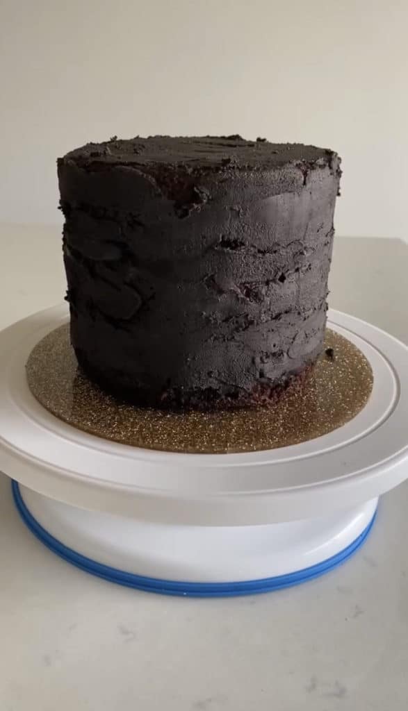 crumb coated chocolate cake with black cocoa powder frosting