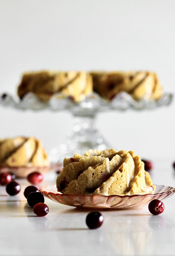 Mini Cranberry Bundt Cakes on cake stand and individual plates