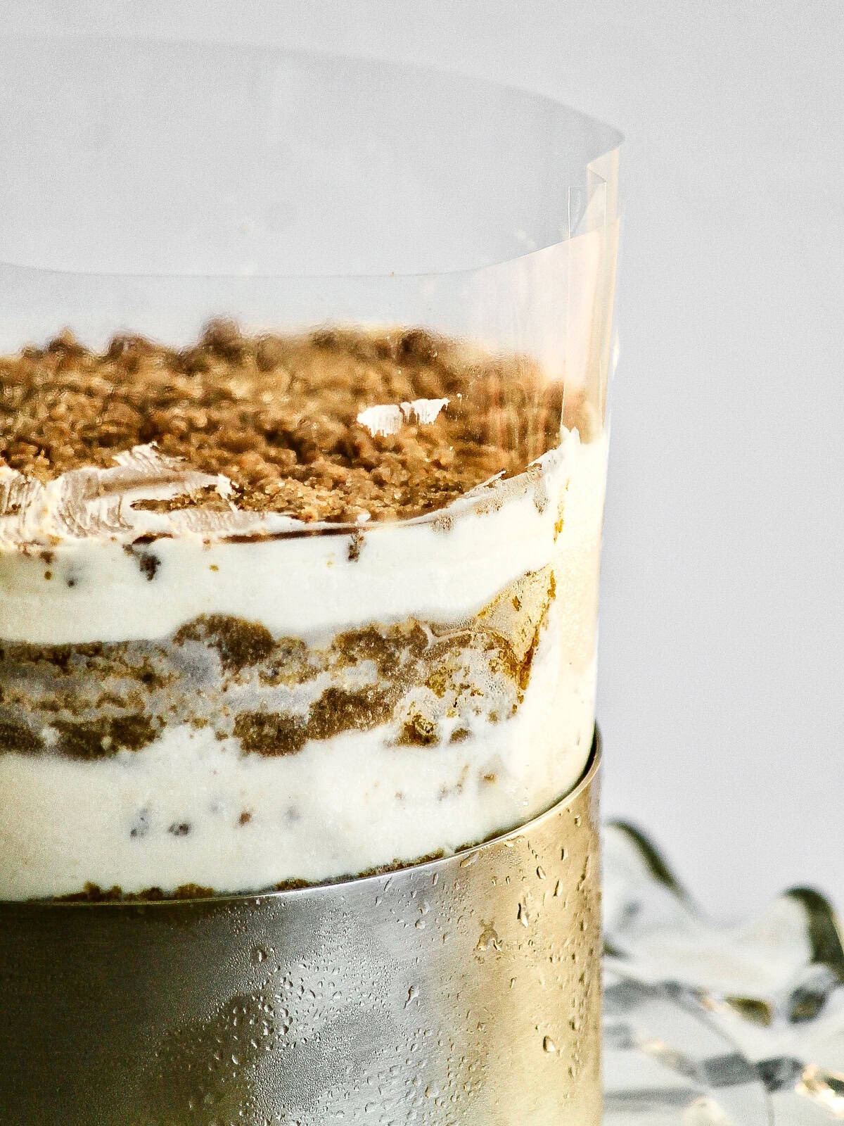 Pumpkin chai cake fully stacked and wrapped in the acetate sheet.