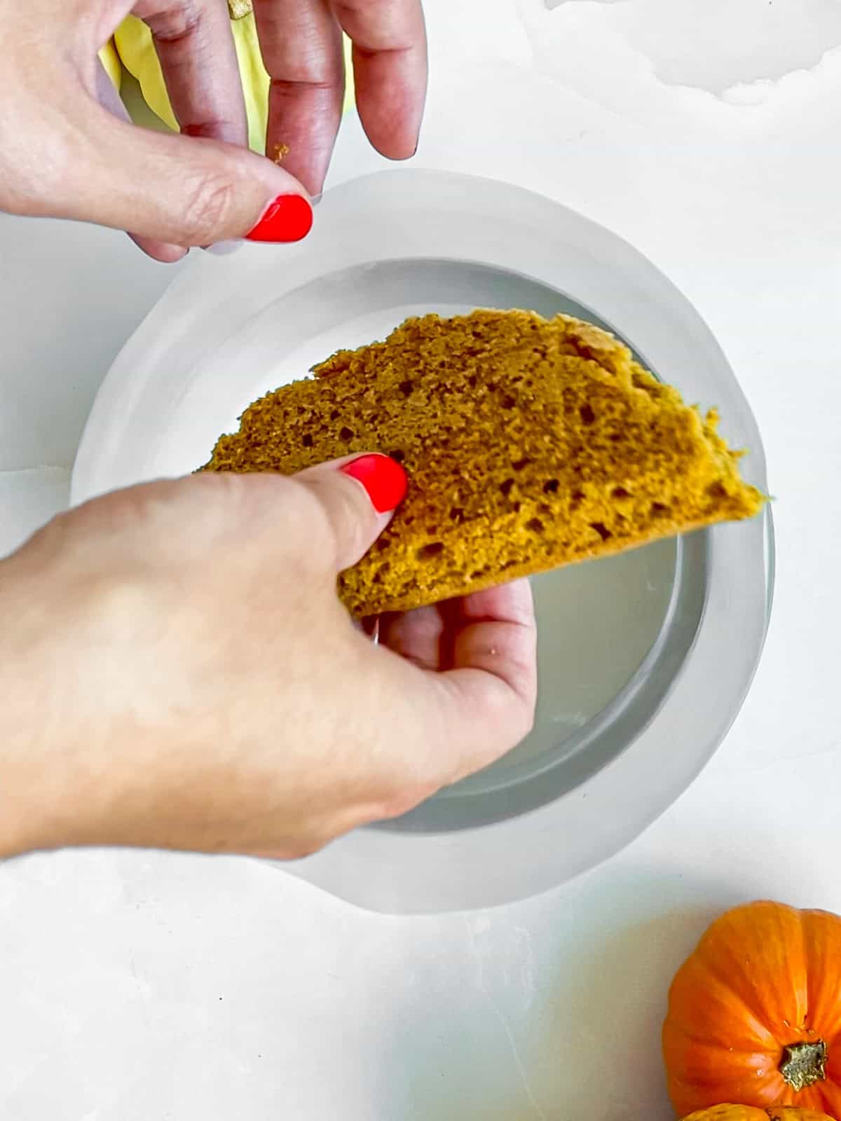 Placing the first of two halves of cake circles into the bottom circle of the cake ring.