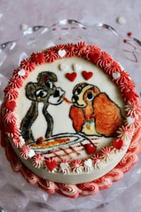 Painted cake featuring lady and the tramp