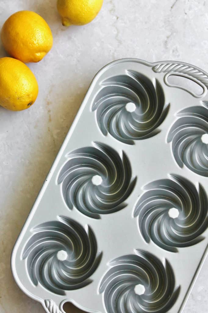 Nordicware mini Bundt cake pan with three lemons off to the upper left hand side