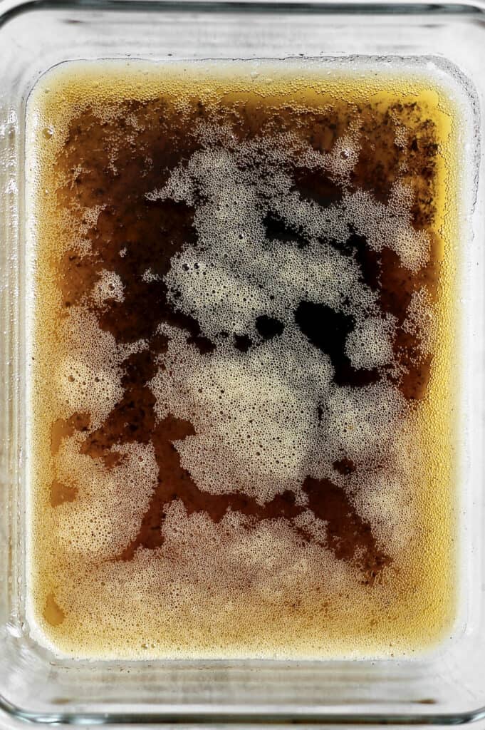 image of melted brown butter, still in liquid form in a flat, rectangular-shaped dish