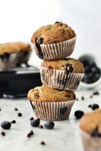 stack of three baked blueberry chocolate chip muffins using fresh blueberries