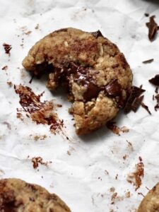 overhead image of baked chocolate chunk cookie with bite missing
