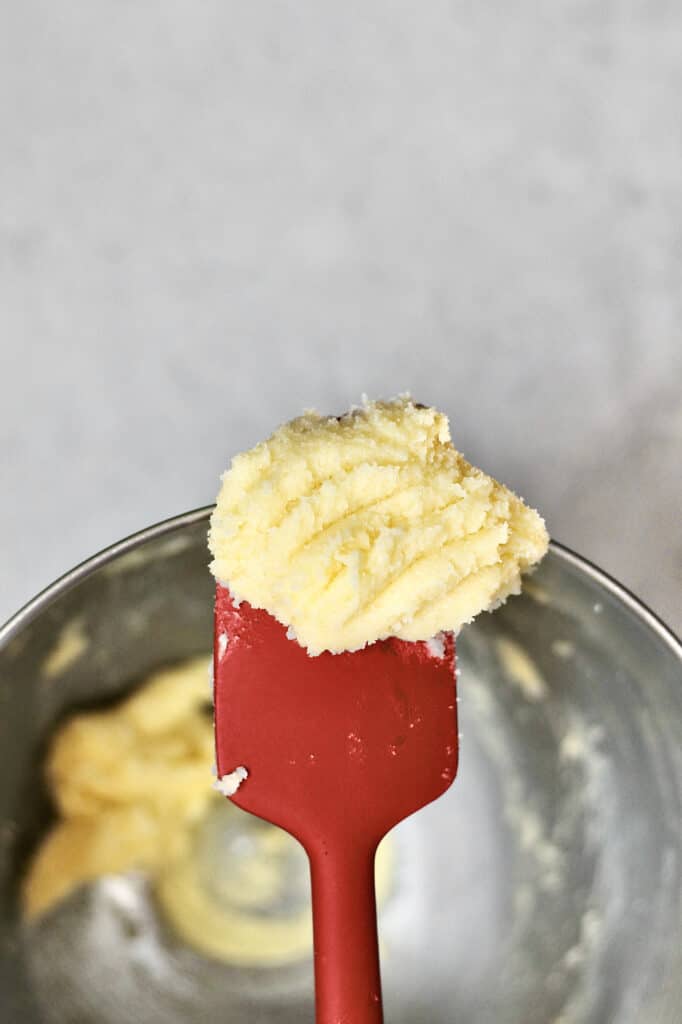 image of butter, sugar, and vanilla and almond extracts creamed together for funfetti muffins