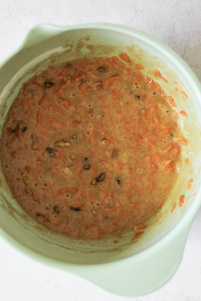 image of shredded carrots and nuts, mixed into the batter for carrot cake