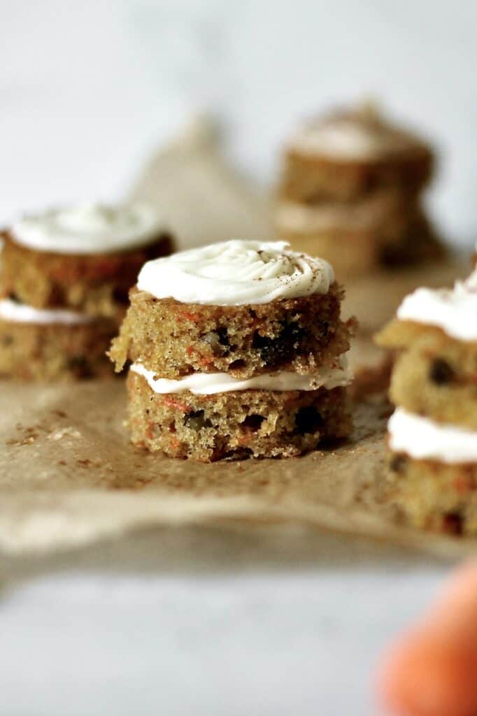 bite-sized layered carrot cake, sitting on a brown piece of parchment paper