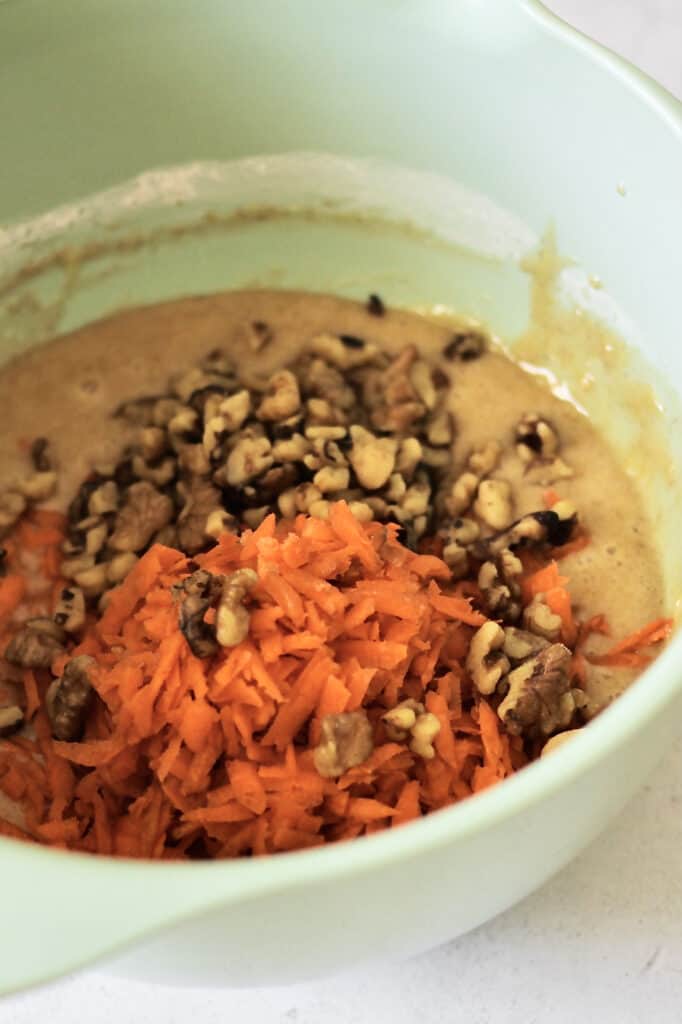 image of shredded carrots and nuts, before they're mixed into the batter for carrot cake