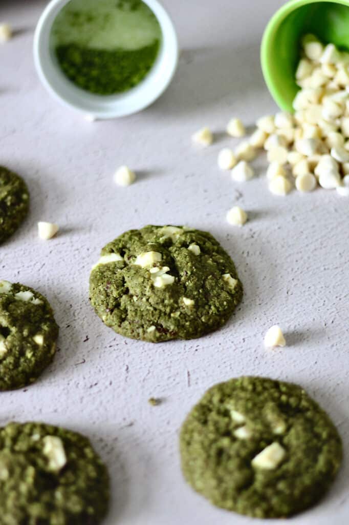 a few matcha cookies, with white chocolate chunks baked into it and chips surrounding it