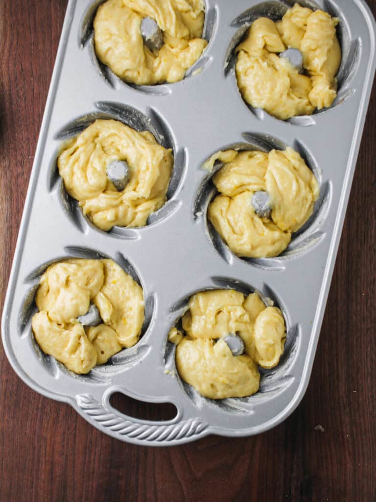 Batter in pan for mini lemon cakes.