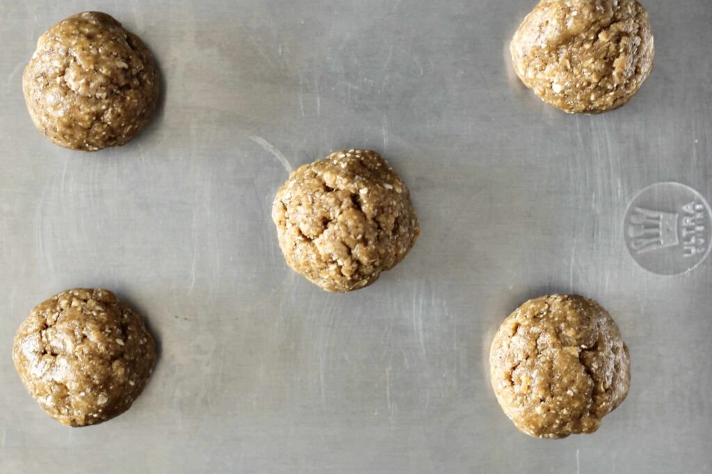 balls of peanut butter cookie dough on a baking sheet