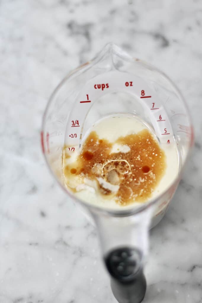 liquid measuring cup with oil, buttermilk, and vanilla extract