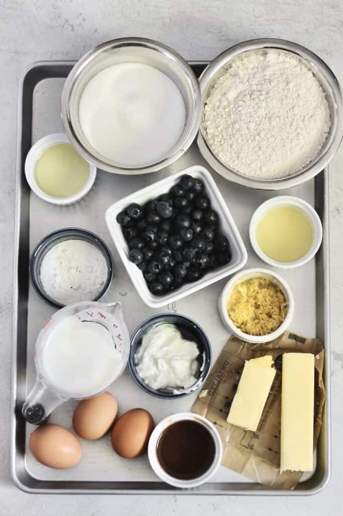 overhead image of ingredients for lemon berry mascarpone cake on an aluminum baking tray