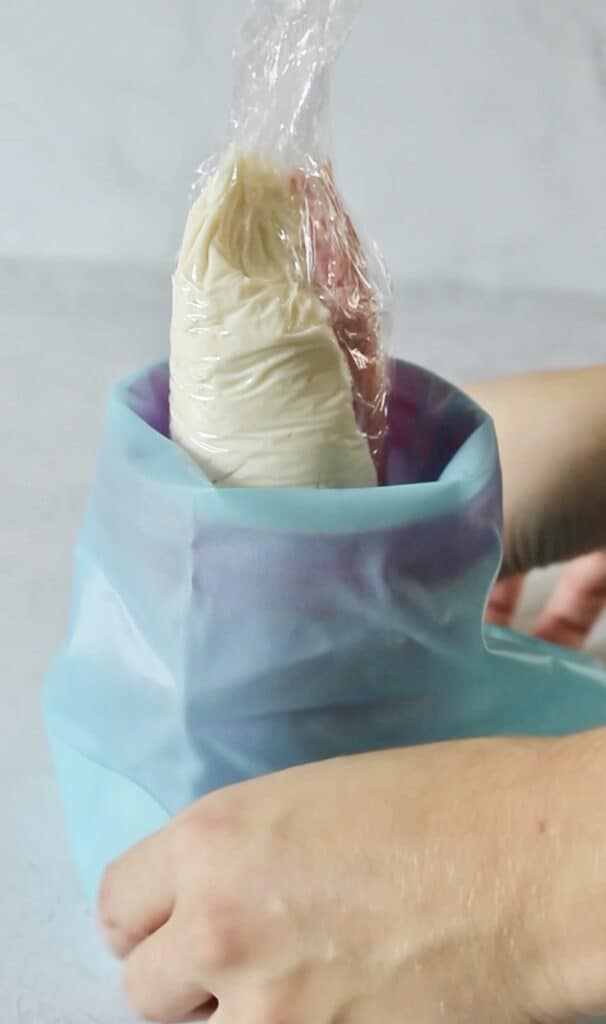 inserting frosting into piping bag for cupcakes