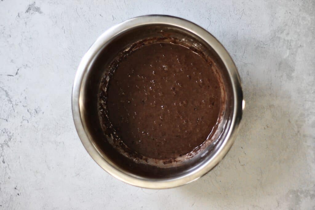 bowl of wet batter, chocolate colored, from mixing the cupcakes