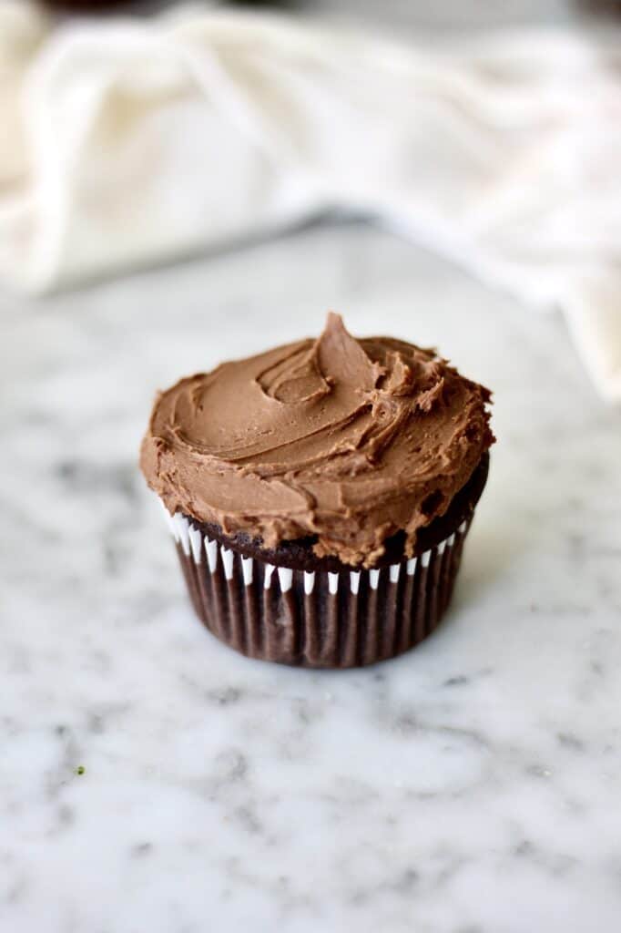 chocolate cupcake topped with whipped chocolate frosting