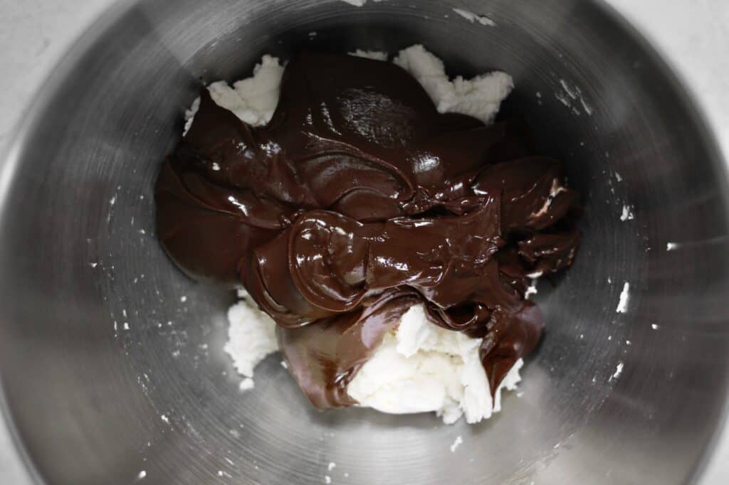 glossy melted chocolate and cream cheese in a mixing bowl