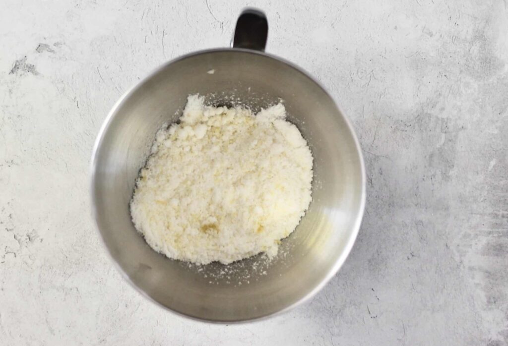 mixing bowl with lemon zest and sugar in it