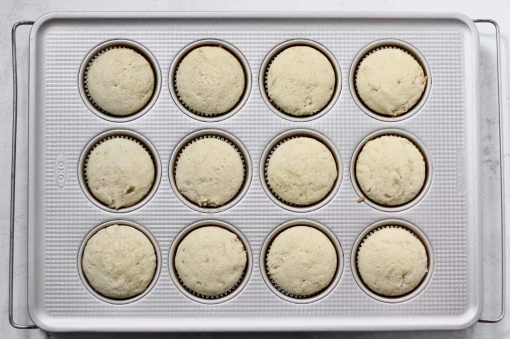 overhead shot of baked vanilla cupcakes for base of strawberry filled cupcake recipe