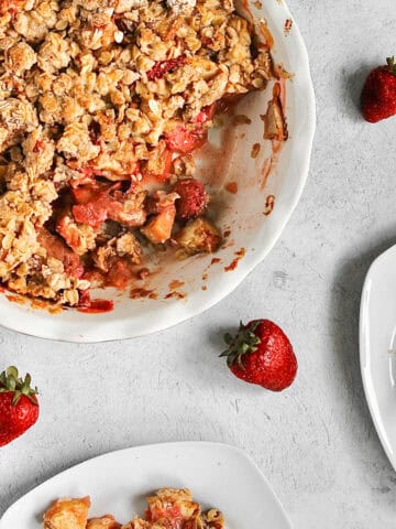 Overhead image of a pie dish containing a baked apple and strawberry crumble.