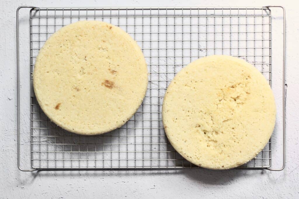 two 8" round baked vanilla cakes