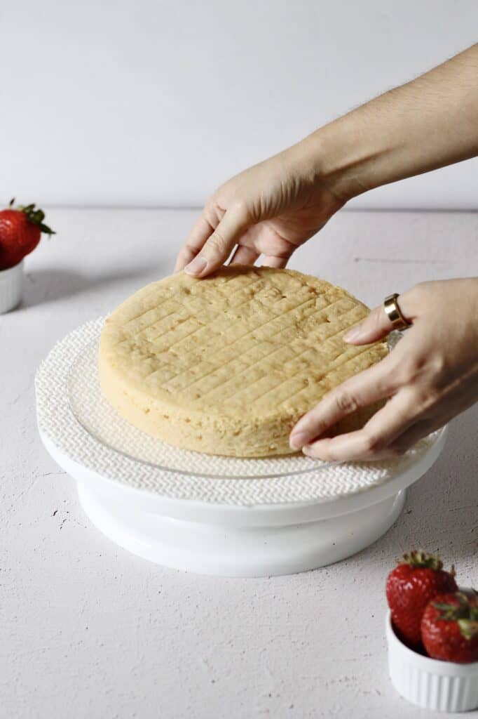 placing first layer of cake on a turntable