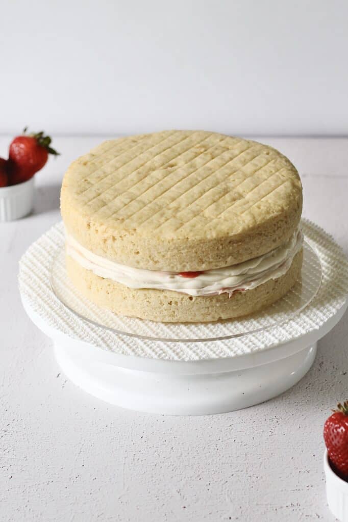 two layers stacked of vanilla cake with strawberry filling