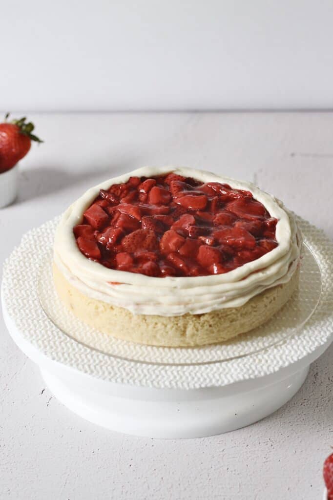 roasted strawberry filling on single layer of cake, bordered by a thick ring of frosting