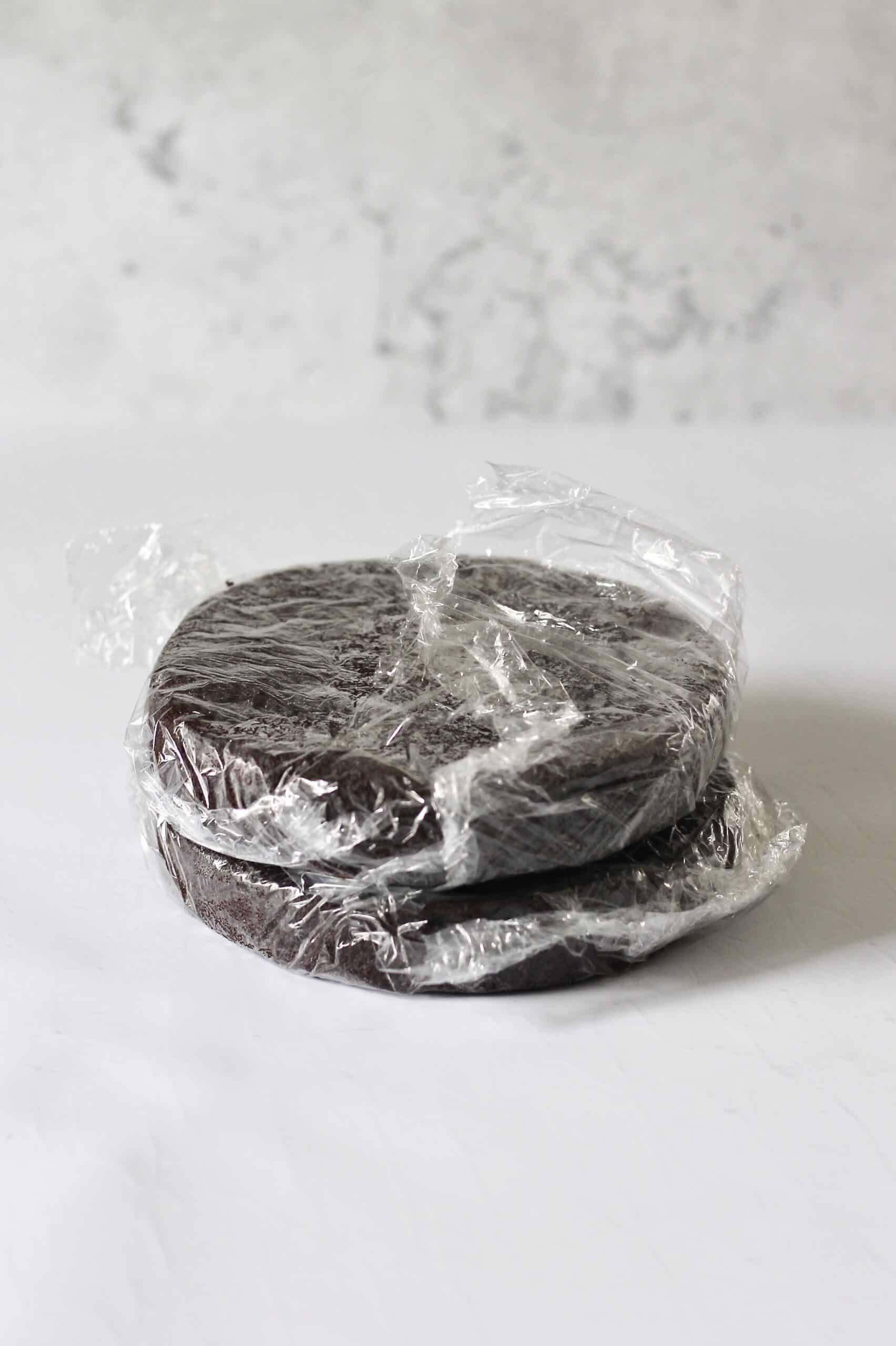 chocolate cake layers wrapped in plastic