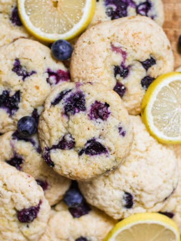 Hero shot for baked blueberry lemon cookies, sitting on a wooden cake stand.