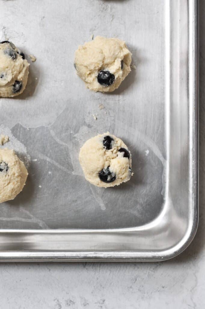 blueberry and lemon cookie dough balls on a baking sheet