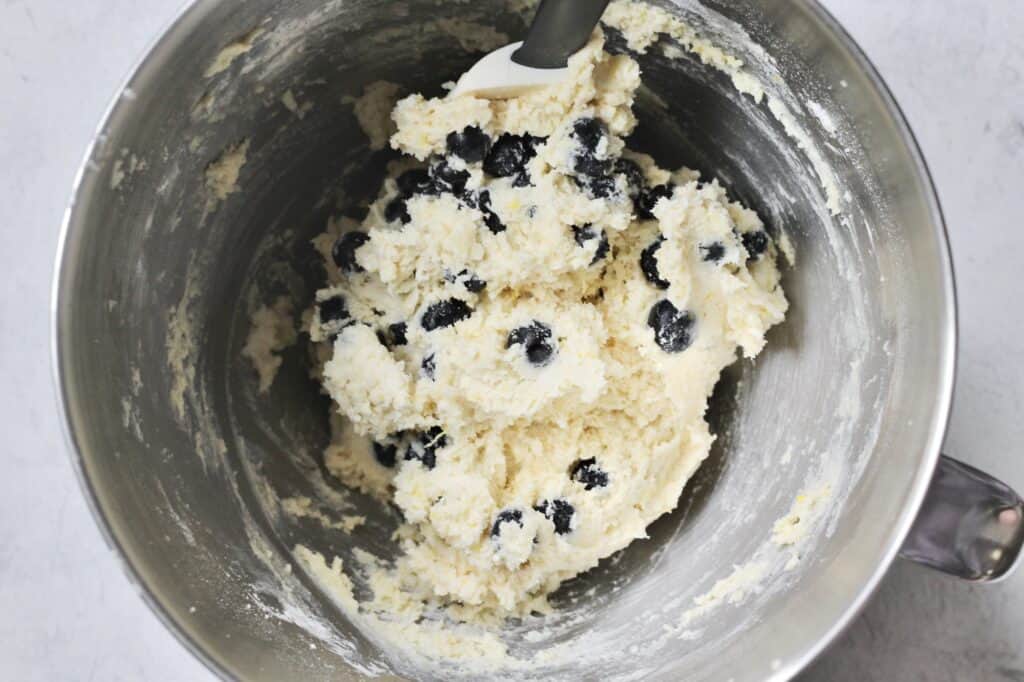 mixing bowl with dough for cookies, after fresh blueberries have been added