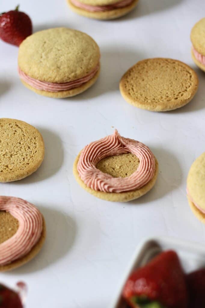 ring of pink frosting on a strawberry cookie sandwich
