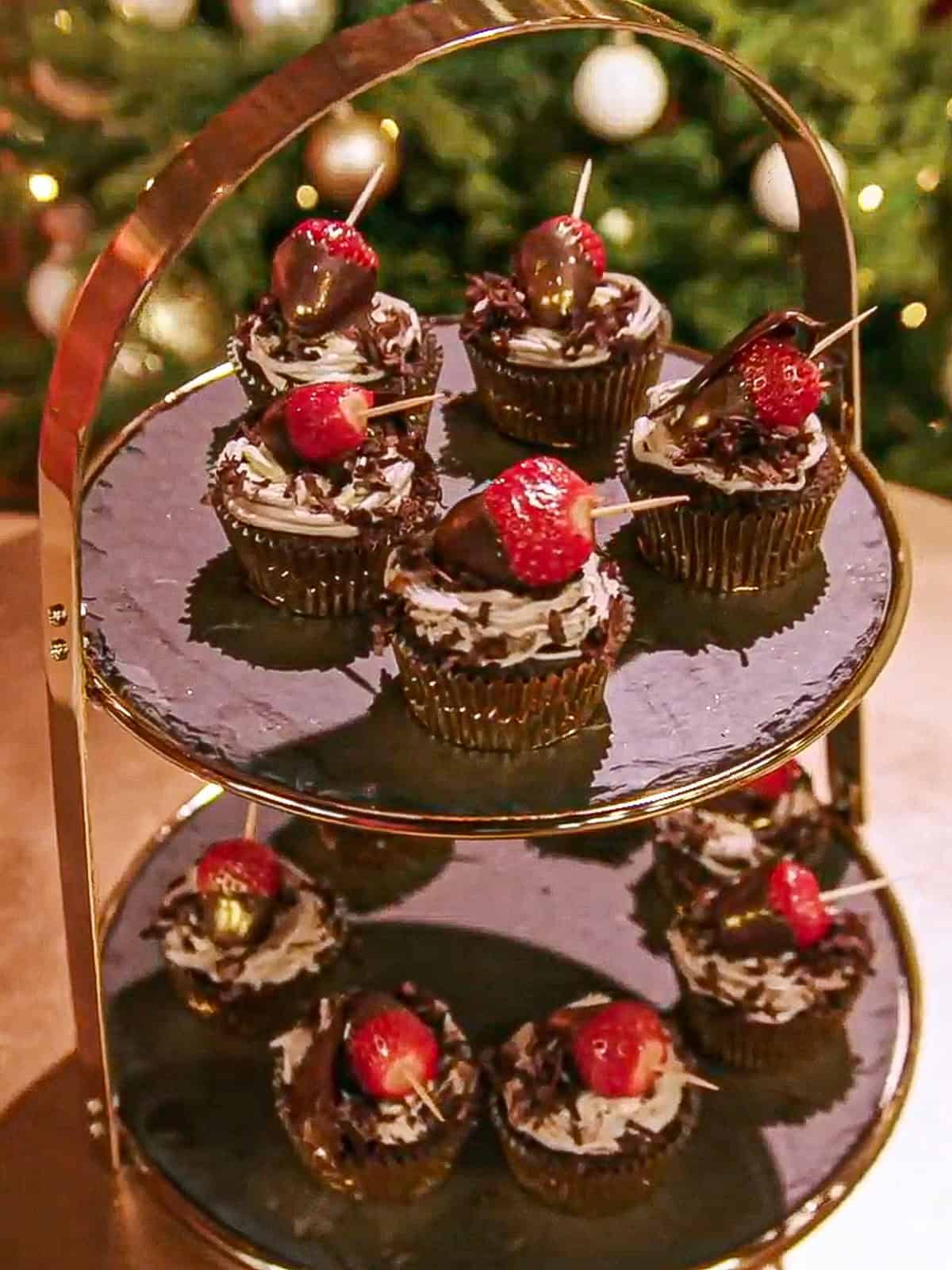 Image from Hallmark Channel's Baked with Love series, with chocolate cupcakes topped with a strawberry on a tiered stand.