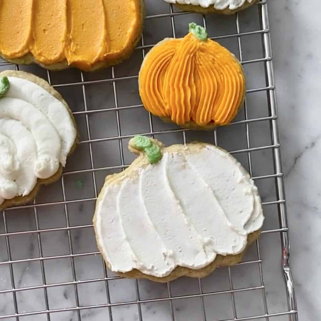 white pumpkin cookie, decorated with a spoon