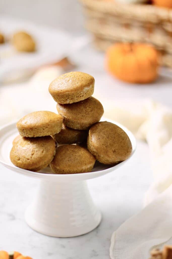 stack of mini pumpkin muffins on a white cake stand