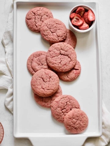 pink sugar cookies on a white platter