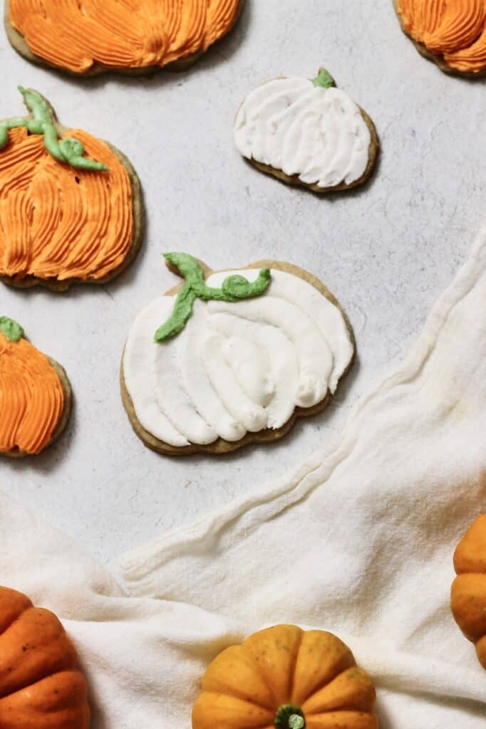 full decorated pumpkin cookies, coated in buttercream