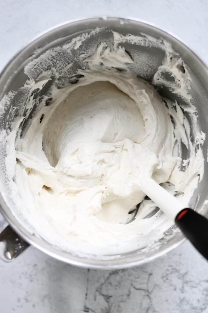 smooth textured homemade almond buttercream frosting in a large mixing bowl