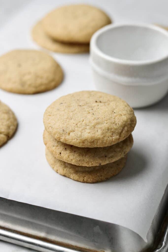 stack of brown butter sugar cookies, sitting on white parchment paper