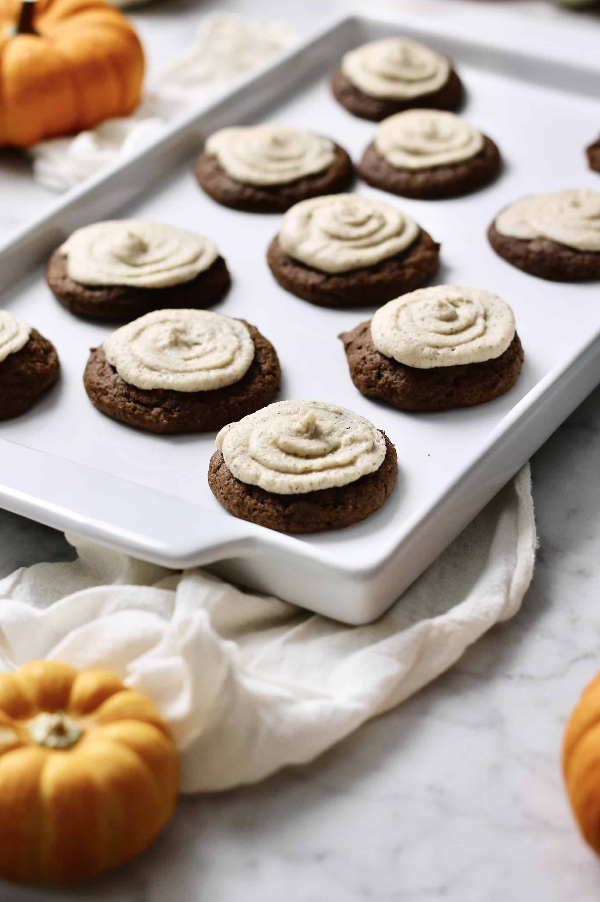pumpkin cookies with a mascarpone espresso frosting, sitting on a white tray