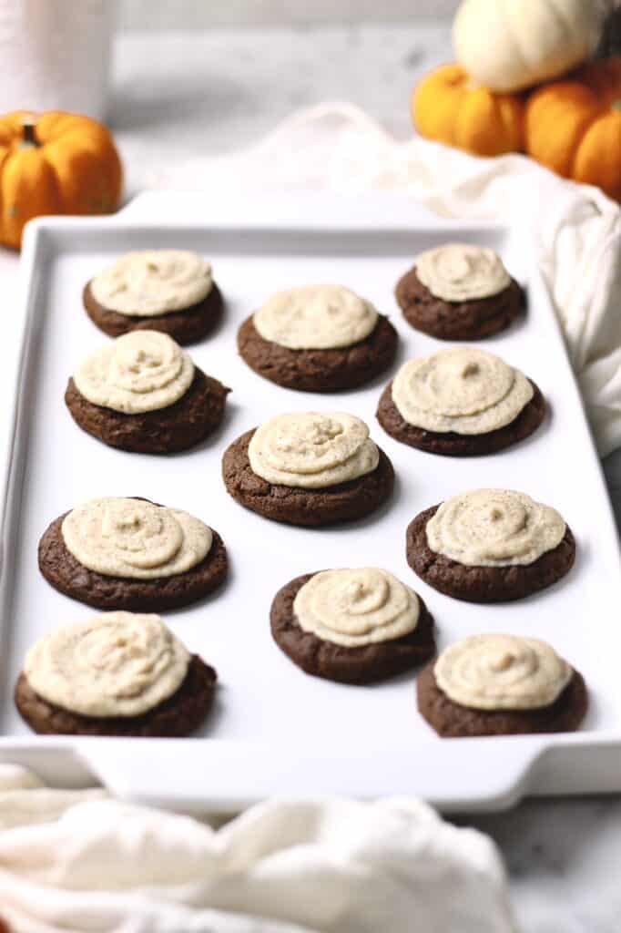 pumpkin cookies with a mascarpone espresso frosting, sitting on a white tray