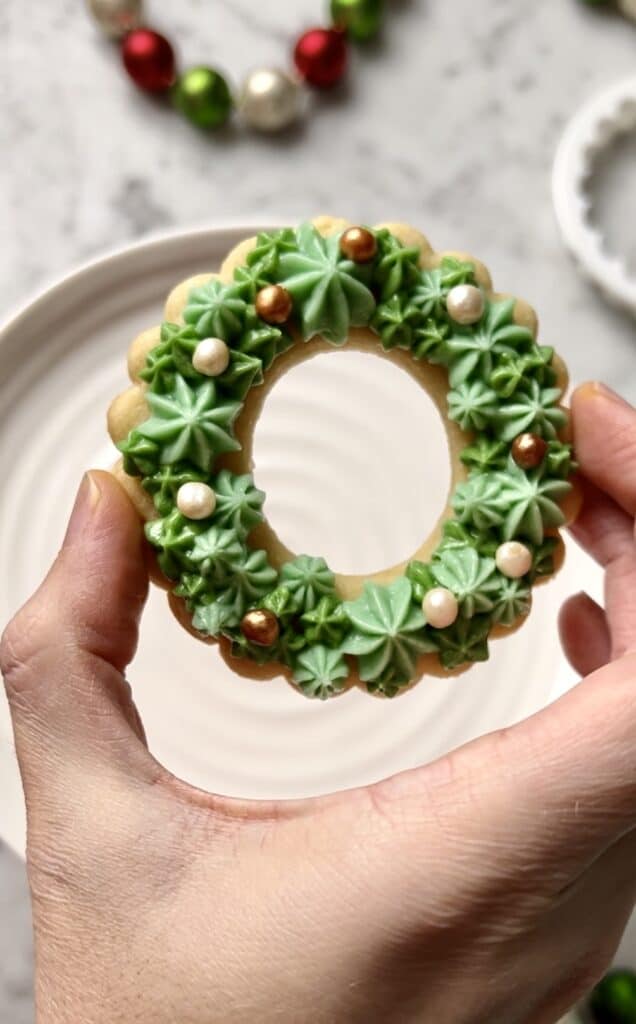 wreath cookie decorated with green buttercream