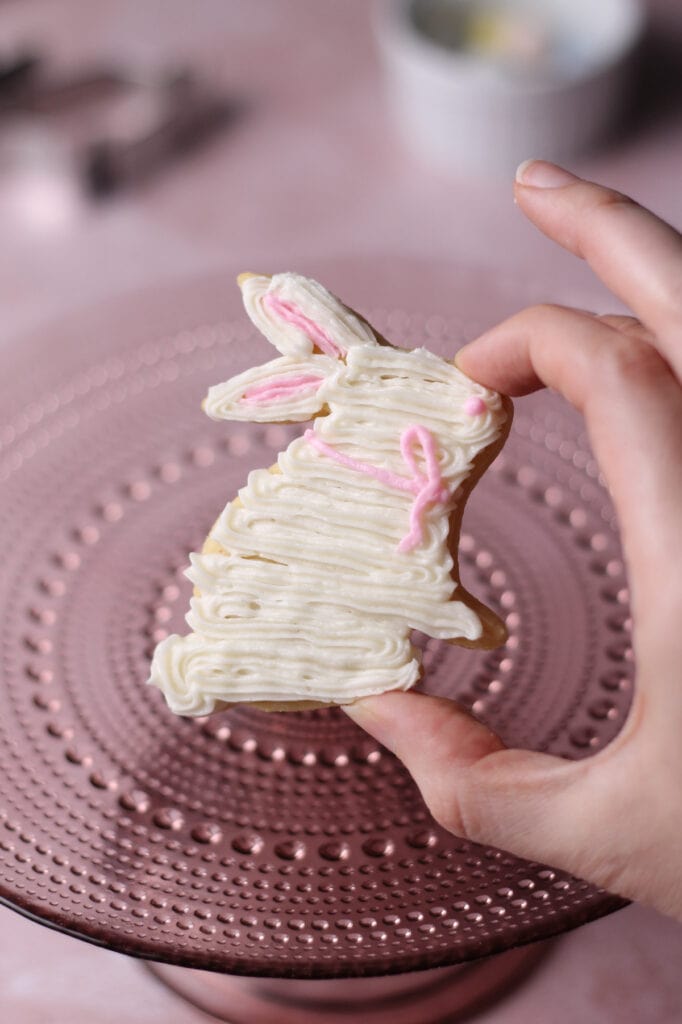 white bunny cookie with a pink bow around its neck