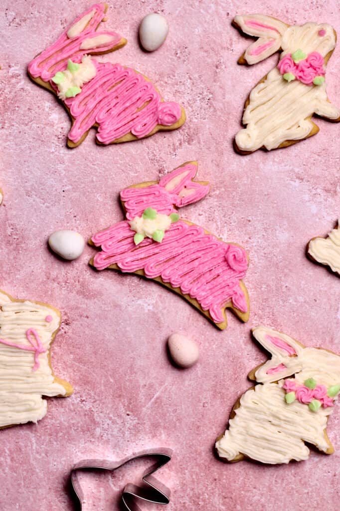 decorated pink and white bunny cookies, sitting on a pink background