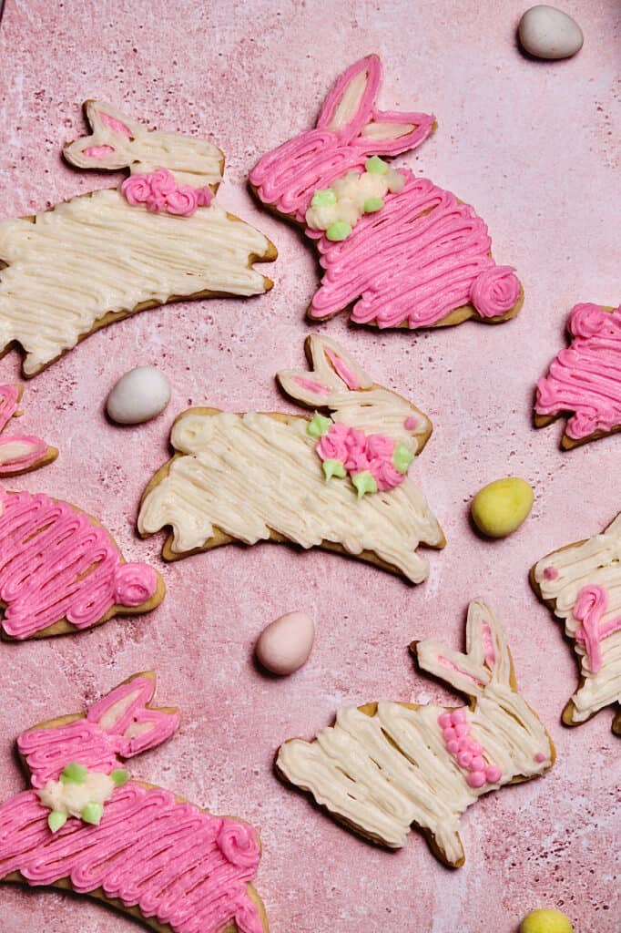 decorated pink and white bunny cookies, sitting on a pink background